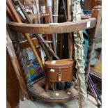 An early 20th Century oak corner umbrella stand with barley twist supports and drip tray - sold with