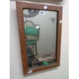 A small Arts and Crafts Movement copper clad framed oblong wall mirror