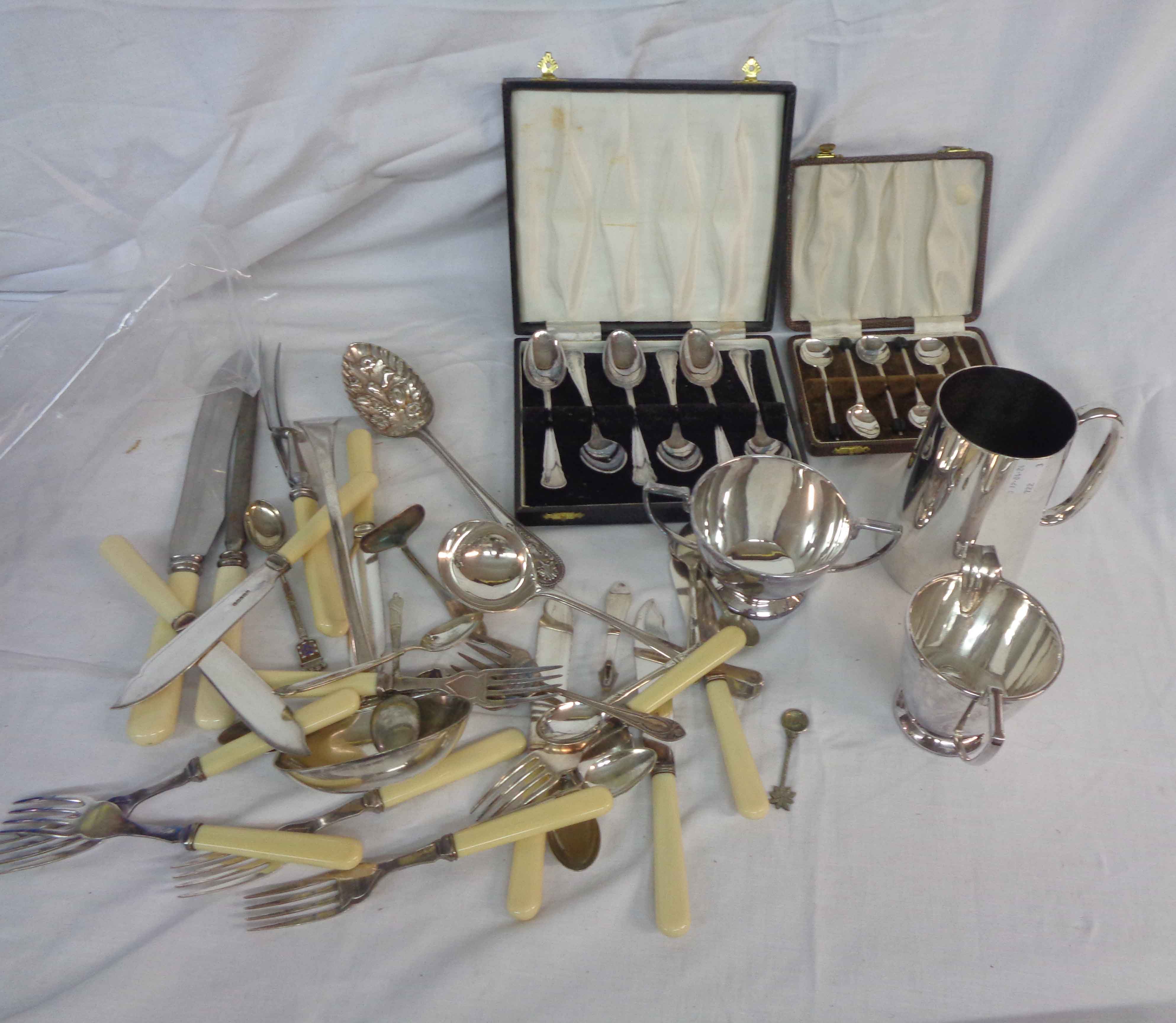 A crate containing a quantity of assorted silver plated items including large ladle, tankard, part