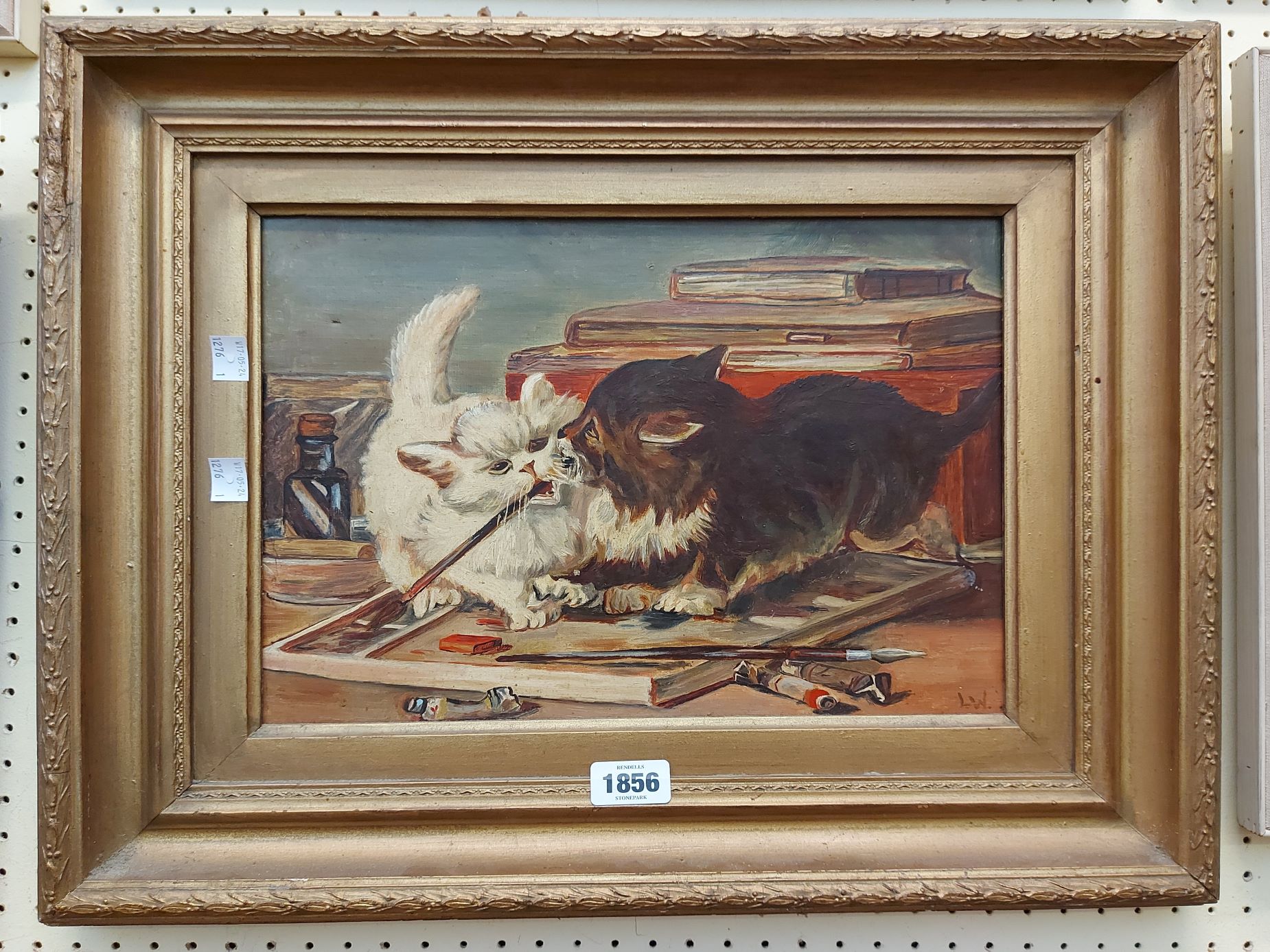 L.W. (manner of Louis Wain): an ornate gilt framed oil on canvas, depicting two kittens fighting