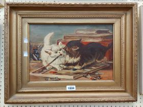 L.W. (manner of Louis Wain): an ornate gilt framed oil on canvas, depicting two kittens fighting