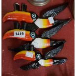 A set of three modern cast iron flying toucans