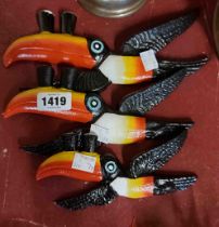 A set of three modern cast iron flying toucans