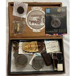 A cigar box containing assorted coins, medallions, cigar cutters, etc.