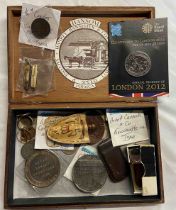 A cigar box containing assorted coins, medallions, cigar cutters, etc.