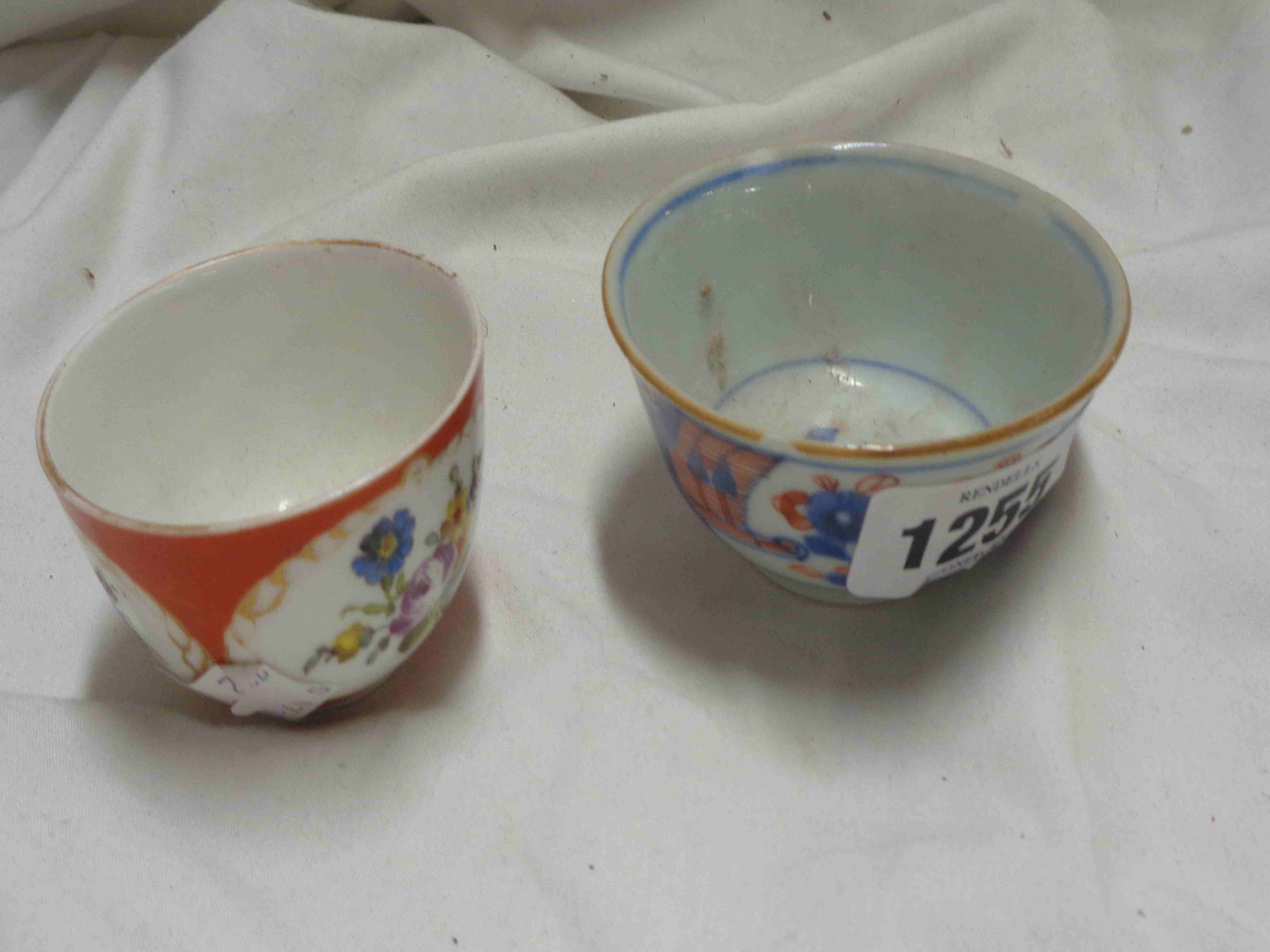 A 19th Century Meissen porcelain small tea bowl with hand painted panelled floral decoration on a