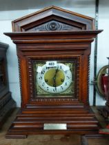 An early 20th Century mahogany cased table clock of architectural design with brass and silvered