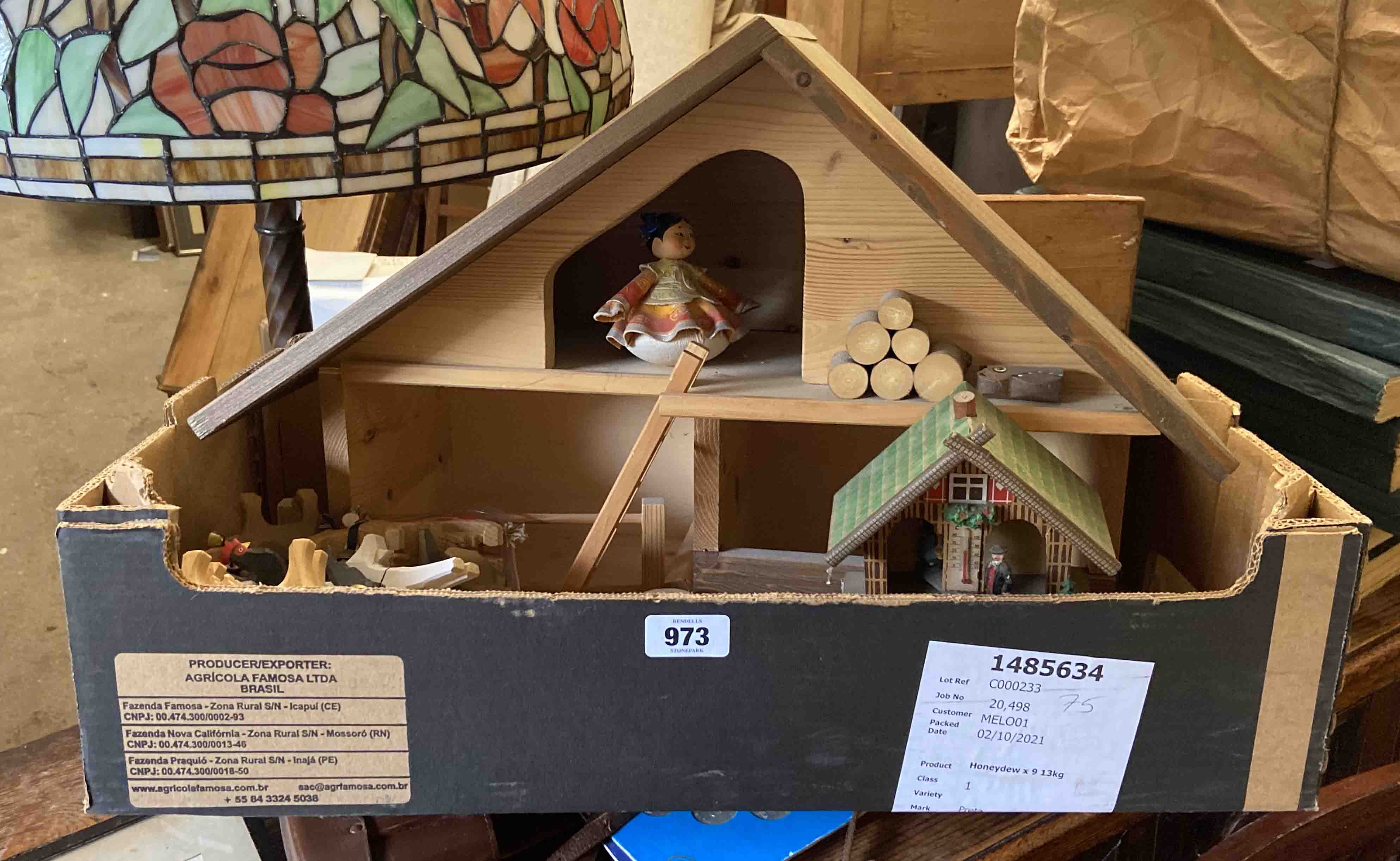 A box containing a model farmhouse with animals and other items
