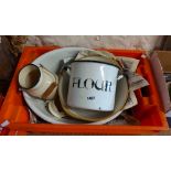 An orange crate containing a quantity of vintage enamelled kitchenware including lidded flour pot,