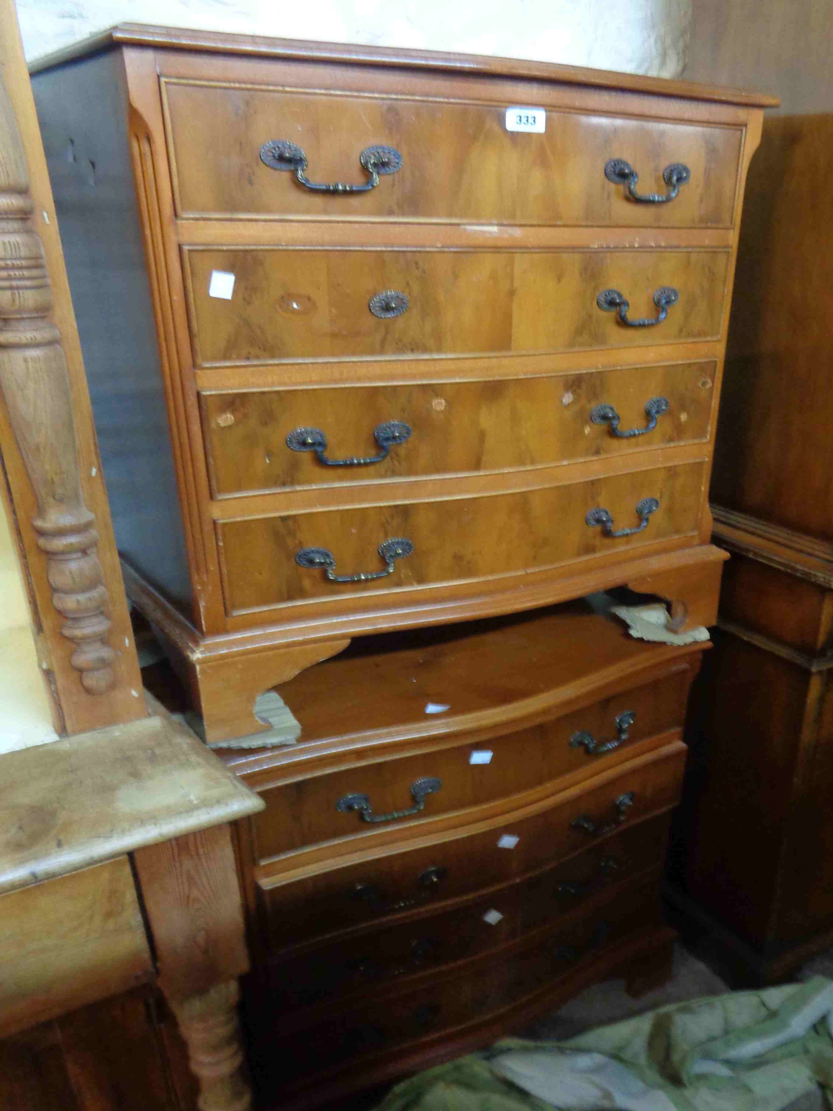A pair of 62cm reproduction yew wood serpentine front chests, each with four long drawers, set on