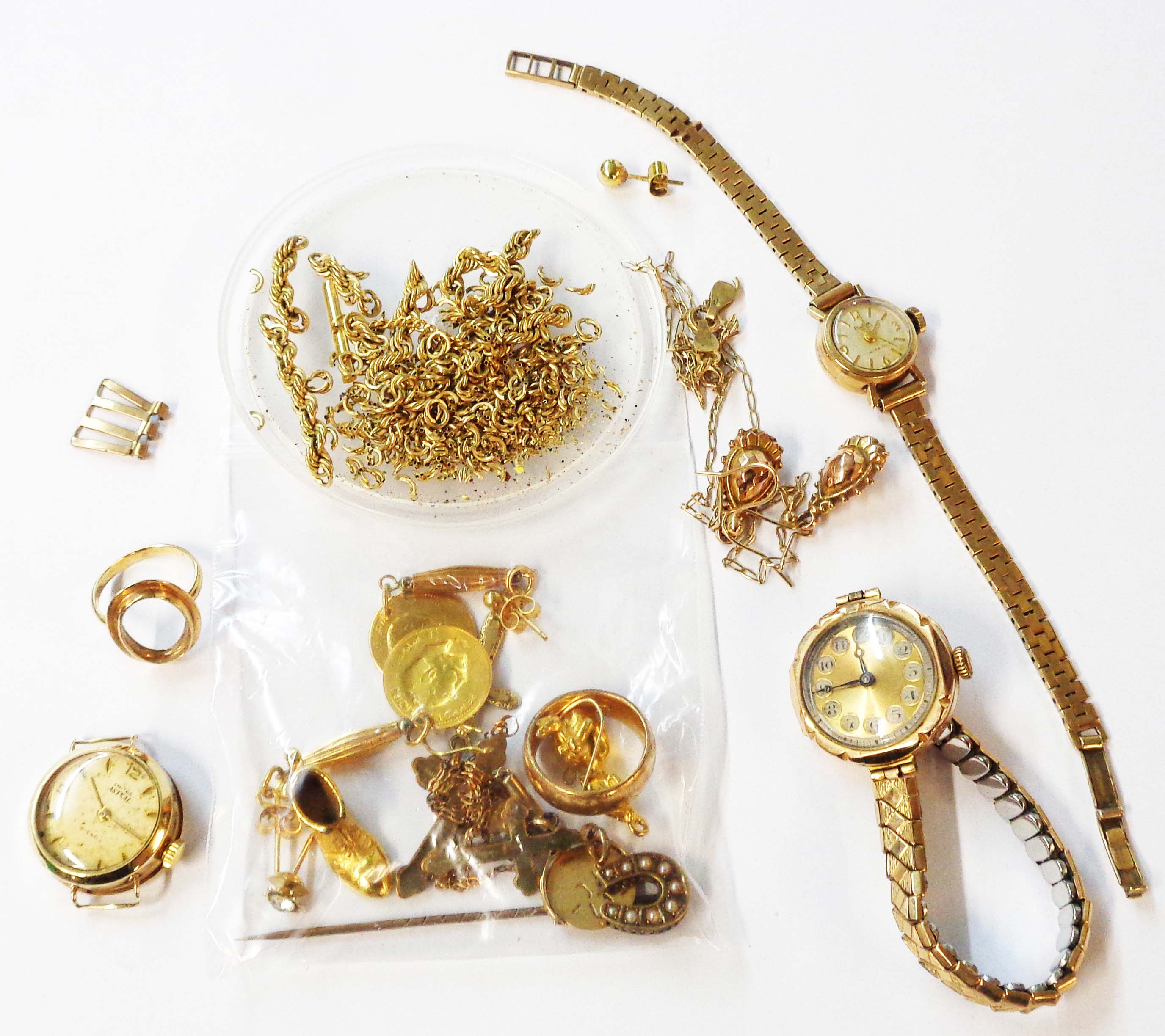 A bag containing three vintage 375 (9ct.) gold cased ladies' wristwatches and a small quantity of