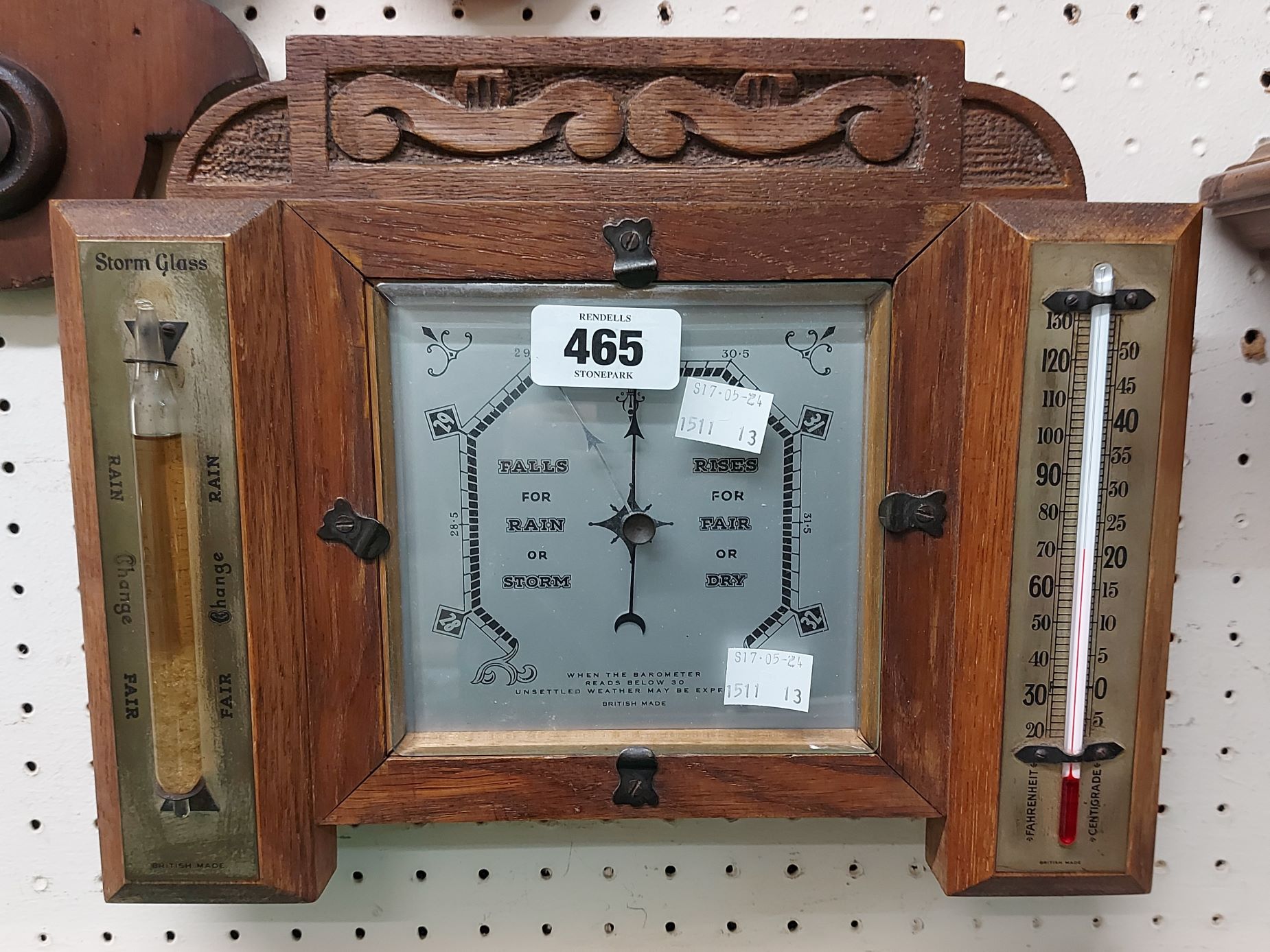 An early 20th Century carved oak framed wall barometer/thermometer with central aneroid works and
