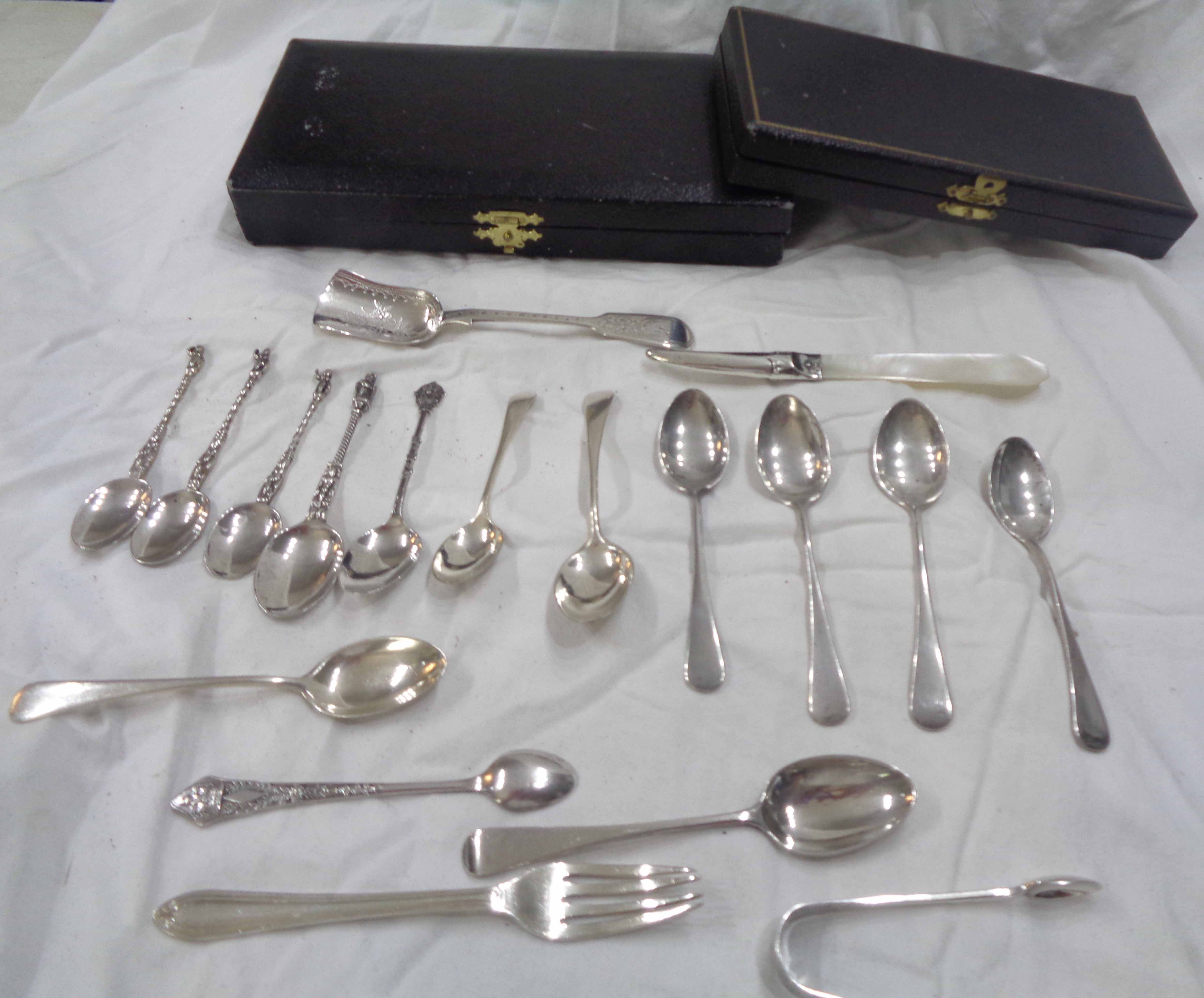 A bag containing a quantity of small silver and white metal cutlery items including silver and