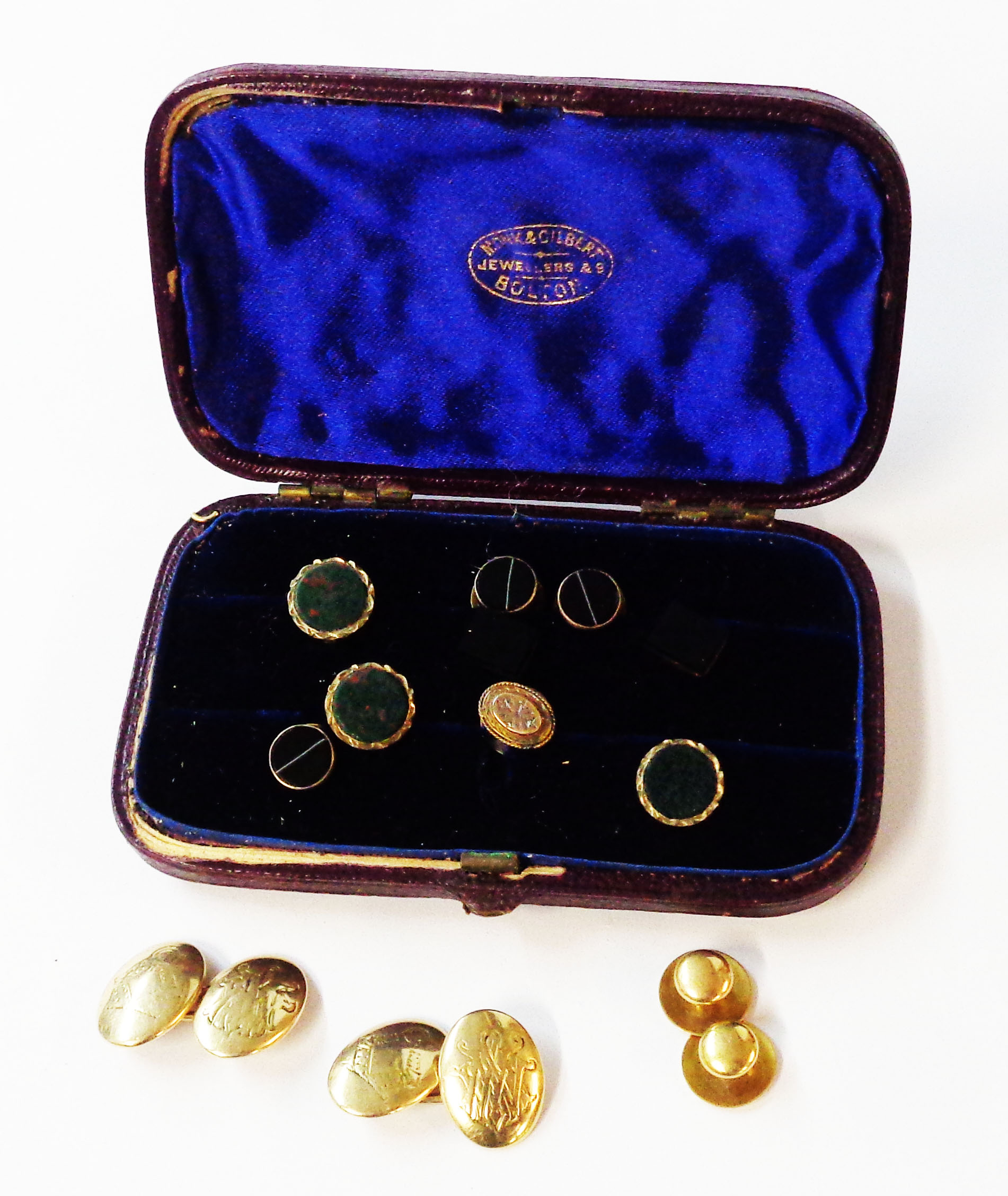 A stud case containing a pair of yellow metal oval panel cufflinks with initials, two marked 15ct.