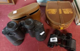 A two set of binoculars and a leather collar box