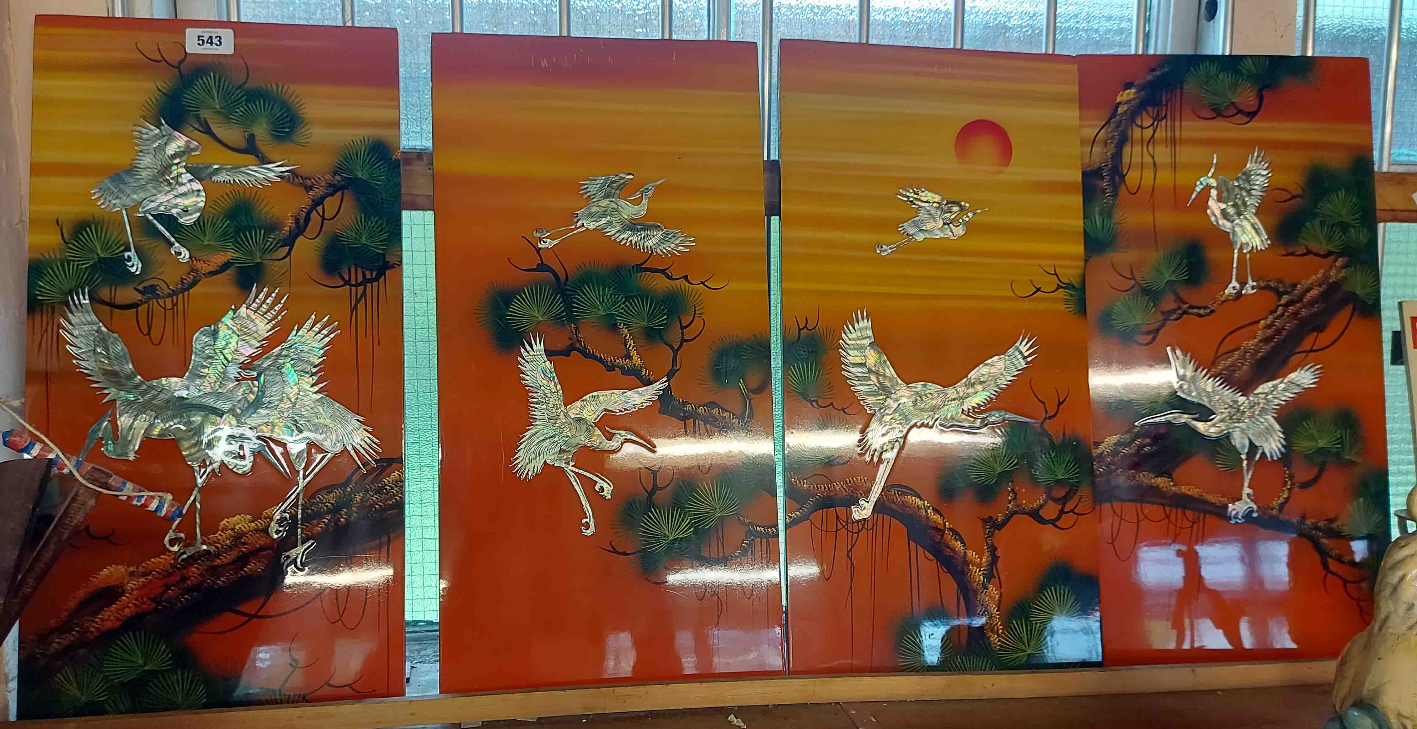 A Vietnamese four section screen with mother-of-pearl and lacquered decoration, depicting birds,