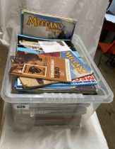 Two boxes containing a quantity of Meccano magazines, axil rods, a wood case of Meccano, etc.