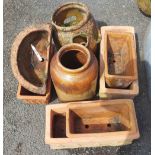 A quantity of terracotta planters and a stoneware pot