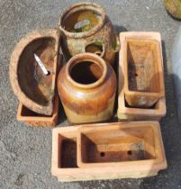 A quantity of terracotta planters and a stoneware pot