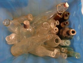 A crate containing a quantity of old glass bottles