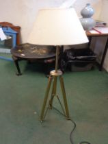 A modern brass standard lamp, set on a folding tripod base - sold with shade