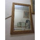 A reproduction gilt framed oblong wall mirror with ribbon and bow decoration to border