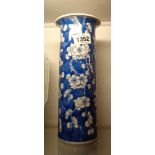 An antique Chinese porcelain vase of cylindrical form with a flared rim and hand painted prunus