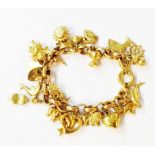 An import marked 375 (9ct.) gold oval-link bracelet, set with numerous hollow yellow metal charms