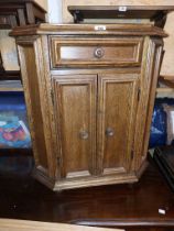 A 66cm vintage oak cabinet with canted corners, single frieze drawer and double cupboard under