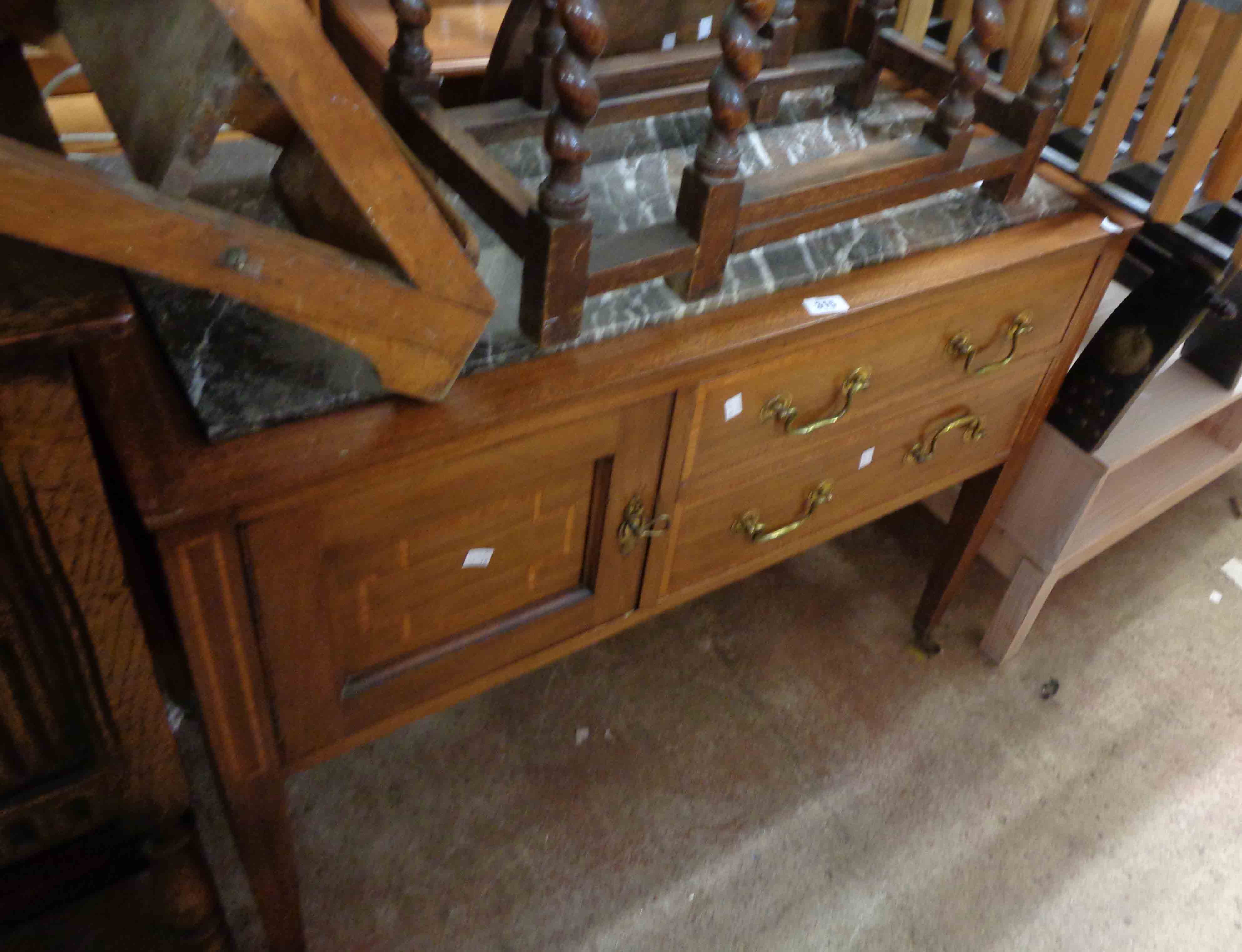 A 1.02m Edwardian mahogany and strung washstand with inset marble top, panelled cupboard door to one