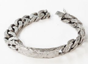 A 1975 silver kerb-link bracelet with blank cartouche and textured finish by Deakin & Francis -