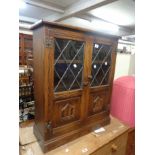 A 72cm vintage Webber Furniture oak cabinet with shelf enclosed by a pair of part leaded glazed