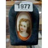 A late 19th Century portrait miniature on curved porcelain panel, depicting a young girl, set in