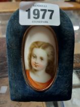 A late 19th Century portrait miniature on curved porcelain panel, depicting a young girl, set in