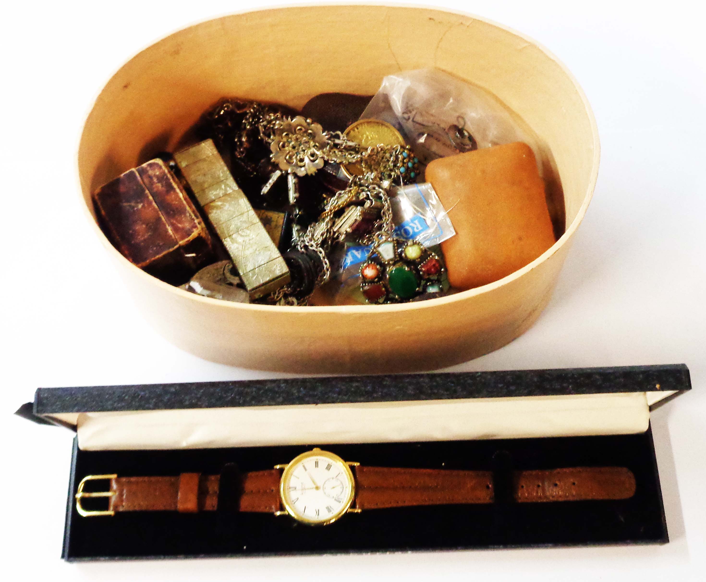 A decorative oval box containing a boxed Accurist quartz goldtone cased wristwatch and various items
