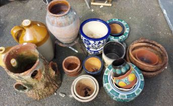 A large quantity of terracotta and glazed garden pots