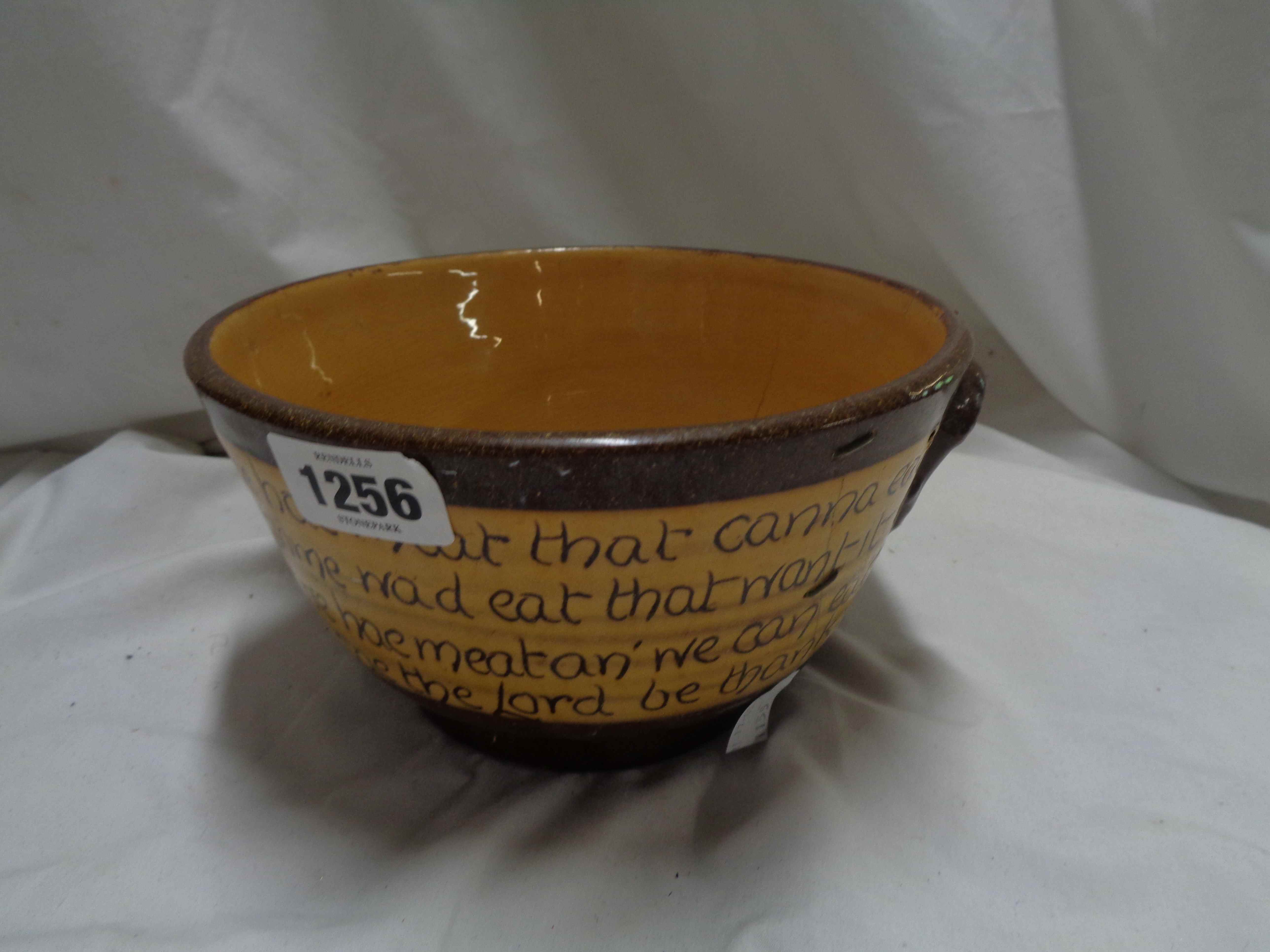 A Scottish pottery bowl, probably Cumnock, with incised motto decoration on a brown and tan glaze