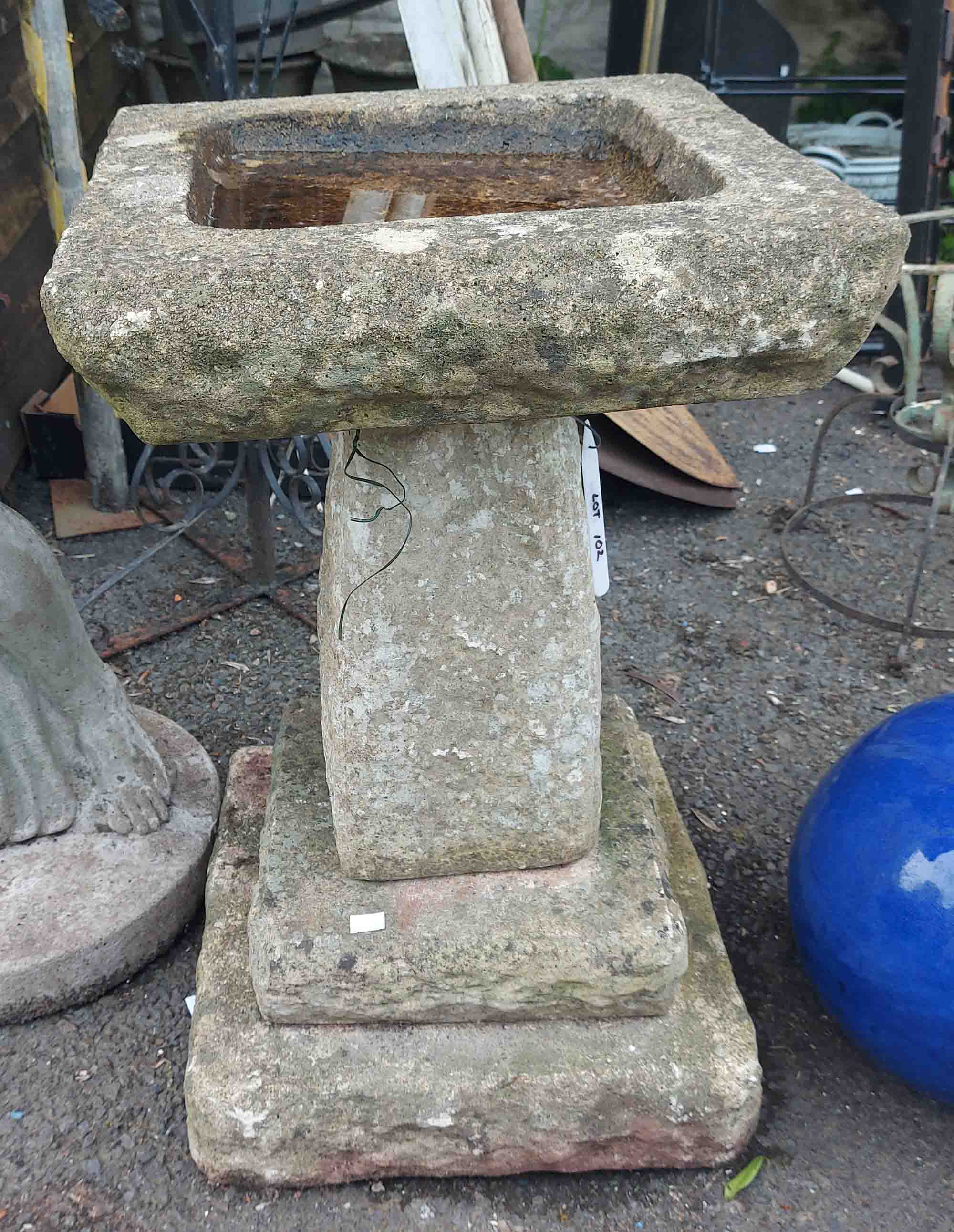 A concrete birdbath