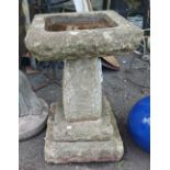 A concrete birdbath