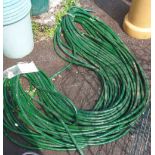 A green reinforced hose pipe - approximately 95m long