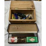 A box containing a small quantity of play worn model cars and a novelty lighter of pistol form -