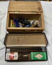 A box containing a small quantity of play worn model cars and a novelty lighter of pistol form -