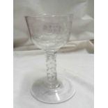 An 18th Century 'Jacobite' wine glass with facet cut stem and conical foot, the bowl decorated