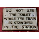 A modern painted cast iron train toilet warning sign