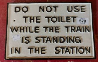 A modern painted cast iron train toilet warning sign