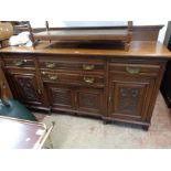 A 2m 20th Century oak sideboard with raised back over a base with two central frieze drawers and