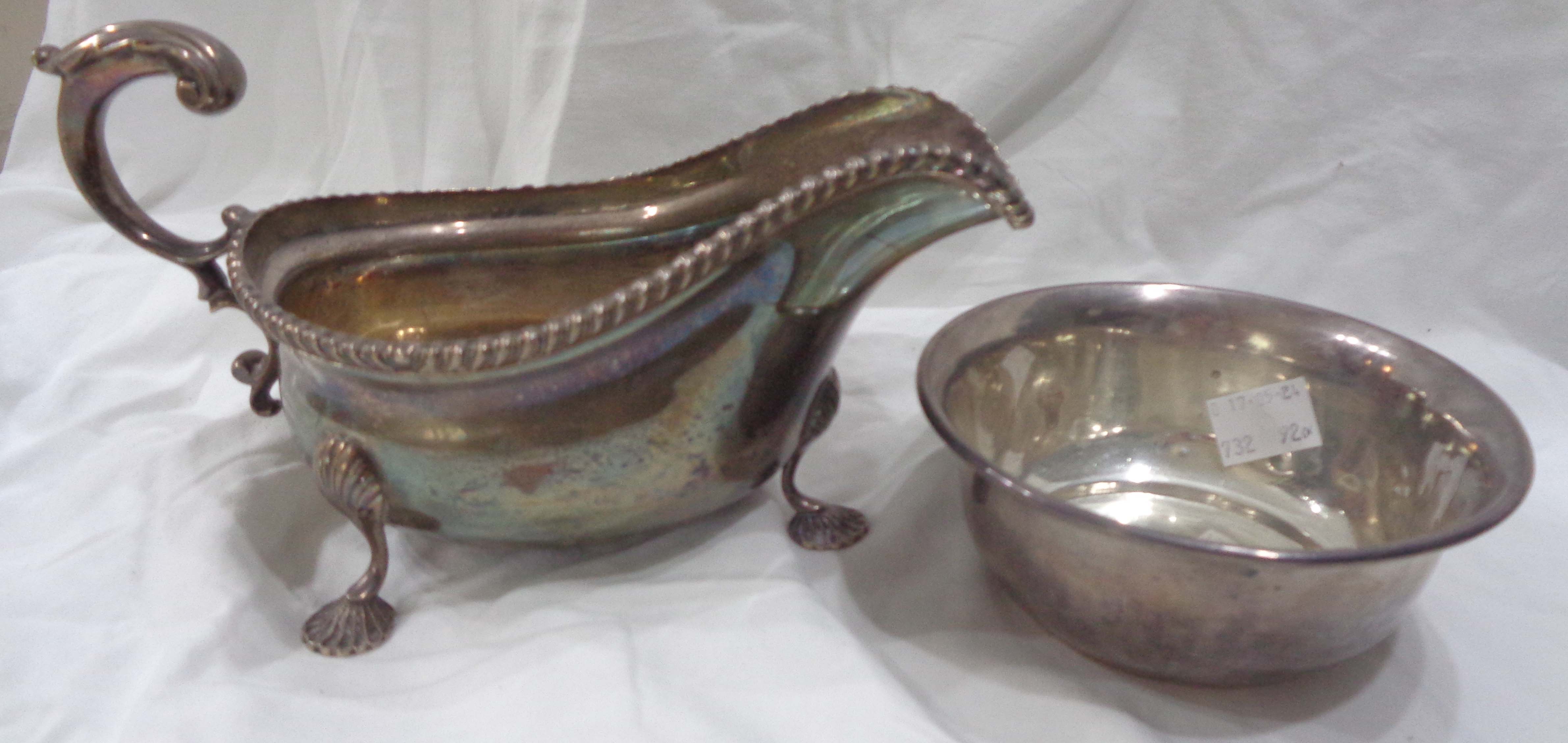 A large silver gravy boat with gadrooned rim, set on stylised pad feet by Barker Brothers -