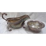 A large silver gravy boat with gadrooned rim, set on stylised pad feet by Barker Brothers -