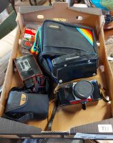 A box containing three vintage cameras including a Praktica Super TL2, etc.