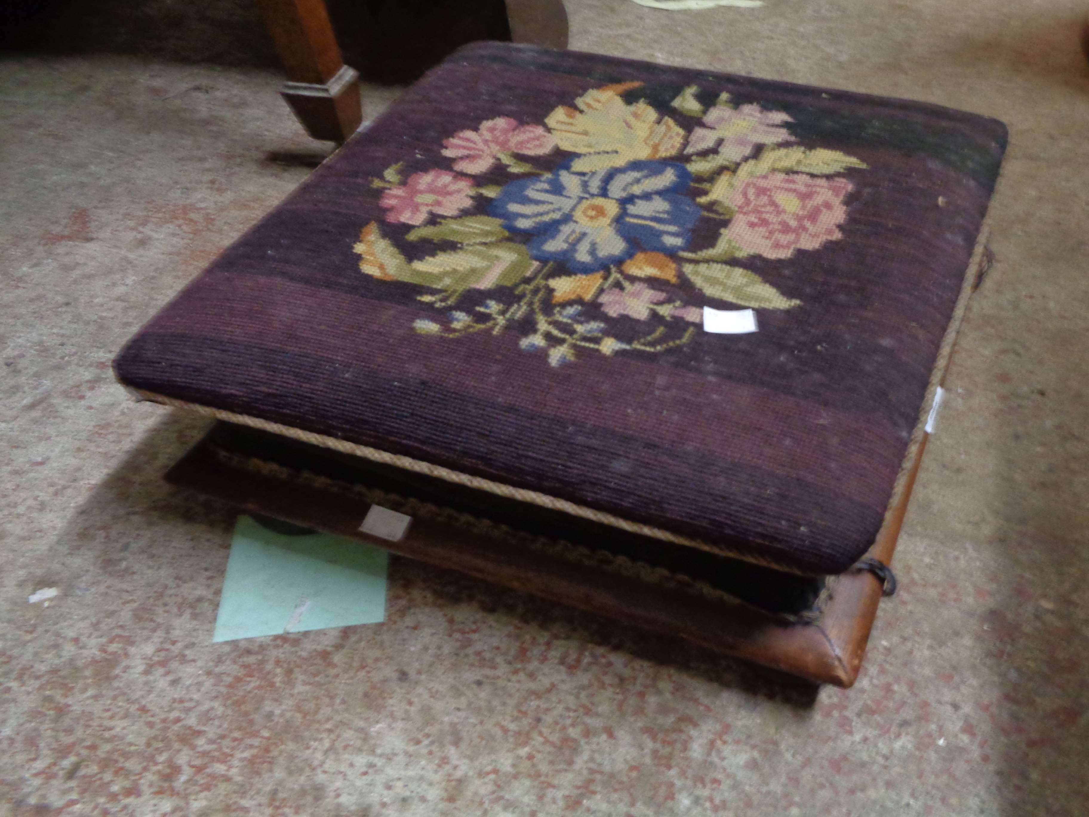 A Victorian square footstool with woolwork upholstery, set on bun feet - piping loss